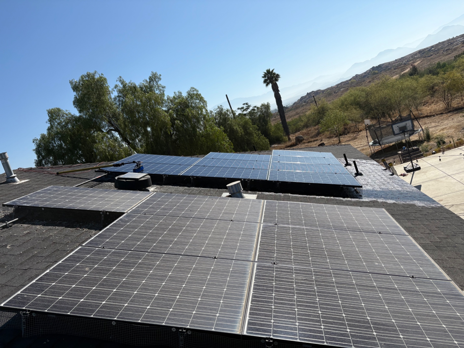 Eclipse Solar Cleaning technician cleaning residential rooftop panels