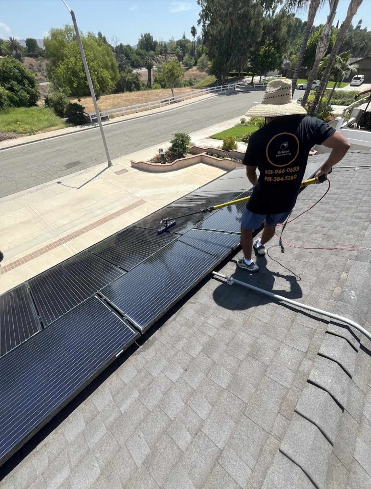Eclipse Solar Cleaning technician cleaning rooftop panels